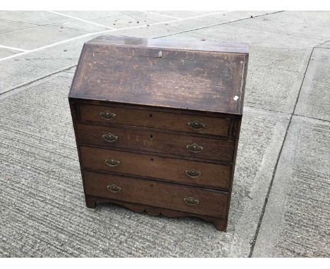 George III oak bureau with fall flap, fitted interior and four long drawers on bracket feet 95 cm wide