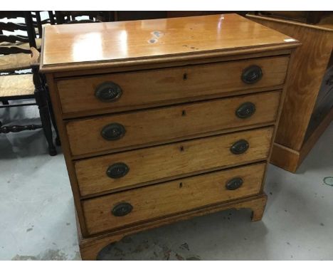 Georgian light mahogany chest of four long graduated drawers with original embossed brass handles and original blue lining pa