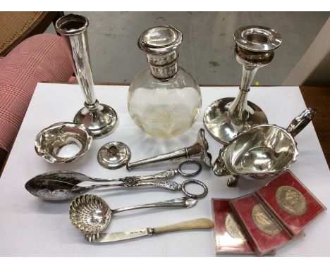 Group silver and plated items including silver candlestick, two silver spill vases (both damaged), silver topped glass bottle