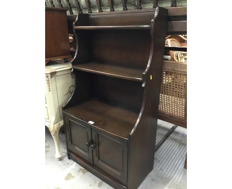 Ercol elm waterfall bookcase with two doors below 61 cm wide, 111 cm high,34 cm deep