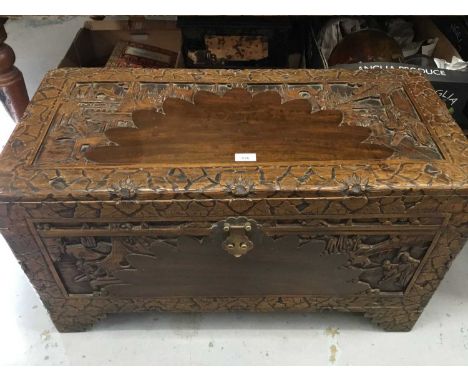 Contemporary Chinese carved camphor wood trunk with decorative figure and landscape panels, on bracket feetCondition report: 