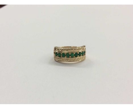 9ct gold green cabochon ring with nine stones in abstract design channel setting, ring size K½Condition report: Weight 4.7g