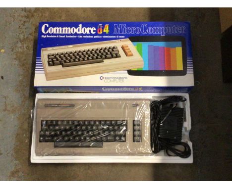 Commodore 64 Micro Computer in box, together with an Amstrad CPC464, vintage cameras, headphones, and a box of tools