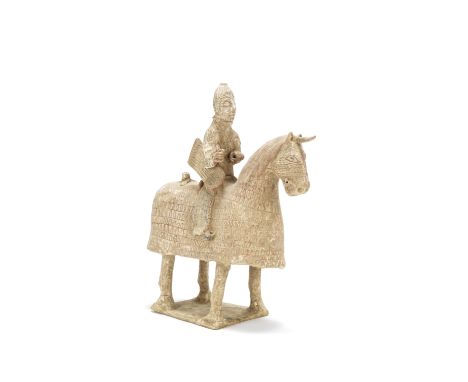 A painted pottery model of an armoured equestrianWestern Jin DynastyThe horse standing four square on a rectangular base, wea