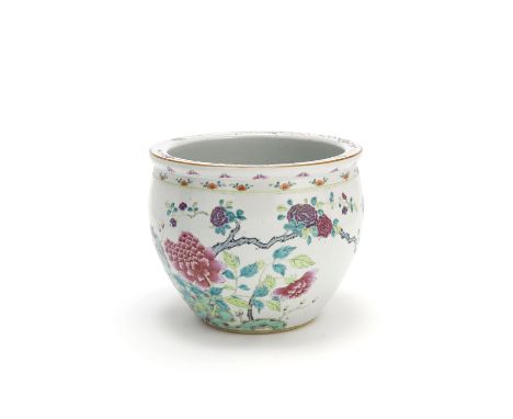 A famille rose planter19th centuryDecorated with large peony blooms issuing from leafy stems, amongst rockwork, the rim with 