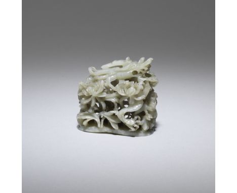 A green jade 'dragon and lotus' hat finialMing DynastyThe green stone with scattered cloudy white and russet inclusions, carv