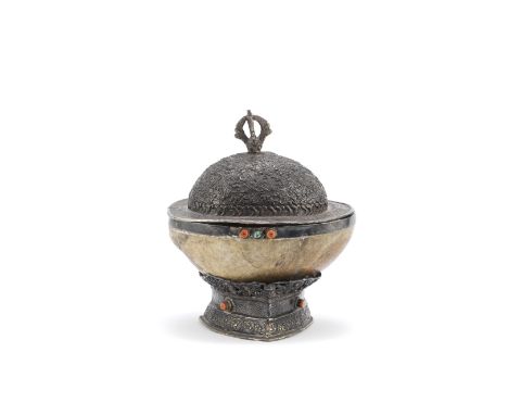 A white metal-mounted kapala, cover and standTibet, 19th centuryThe part-reticulated white metal mount and rim inset with cor