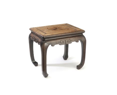 A huanghuali stoolProbably 19th centuryWith recessed shaped top resting above four arched corner legs terminating in scroll f