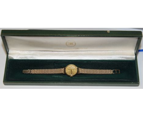 IWC (International Watch Company) 18ct gold wristwatch on a 9ct gold bracelet, circa 1968. Signed circular champagne dial, 20