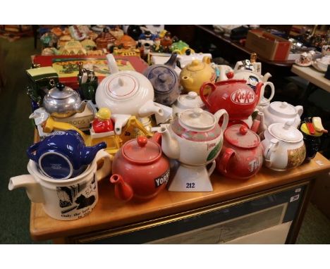 Large collection of Novelty Teapots to include Marmite, Kit Kat, Ransomes Lawnmowers, JCB, Black and White Scotch Whisky etc.