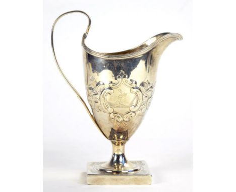 A GEORGE III SILVER HELMET SHAPED CREAM JUG ON SQUARE FOOT, LATER CHASED, 14CM H, BY PETER AND ANN BATEMAN, LONDON 1795, 3OZS