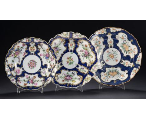 THREE WORCESTER SCALE BLUE GROUND PLATES, C1770 enamelled with different floral patterns, 19.5-23cm diam, fretted square or o