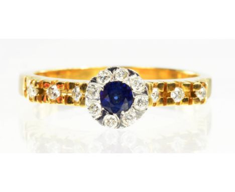 A SAPPHIRE AND DIAMOND CLUSTER RING WITH DIAMOND SHOULDERS, IN GOLD MARKED 750, SIZE O, 4.7G