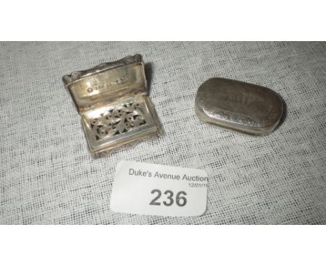 A VICTORIAN VINAIGRETTE of shaped rectangular form, with engine-turned decoration, monogrammed, with foliate pierced grill, b