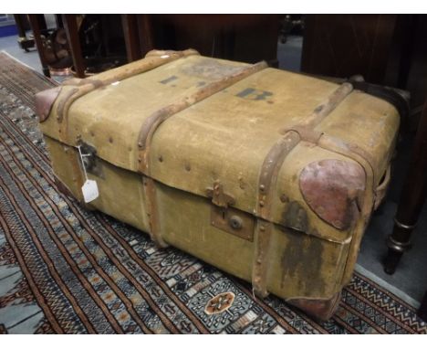 A CANVAS WOODEN BOUND TRUNK with leather corners