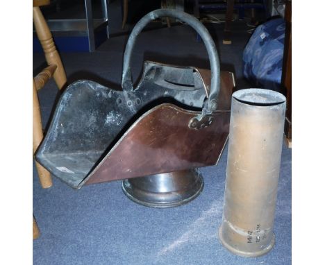 A 19TH CENTURY COPPER HELMET COAL SCUTTLE and a brass shell case