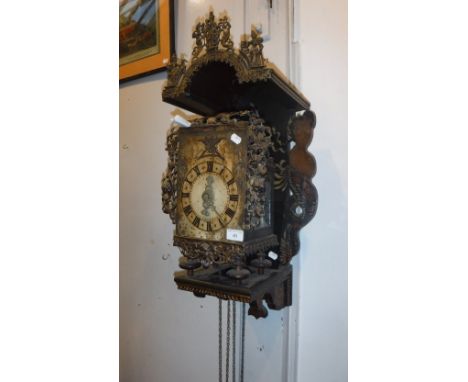 A 17TH CENTURY STYLE DUTCH WALL CLOCK with lantern clock movement and elaborate external castings. The wooden wall bracket wi