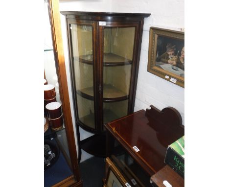 AN EDWARDIAN BOWFRONTED CORNER DISPLAY CABINET with shelf below and a small Edwardian mahogany display cabinet