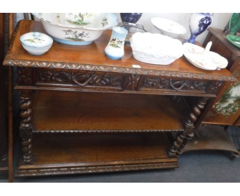 A LATE 19TH CENTURY THREE TIER OAK BUFFET with spiral turned supports and carved decoration, circa 48" wide