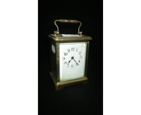 A BRASS-CASED CARRIAGE CLOCK, with white enamel dial