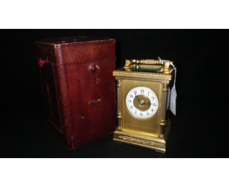 A BRASS-CASED CARRIAGE CLOCK striking on a gong, in leather travelling case