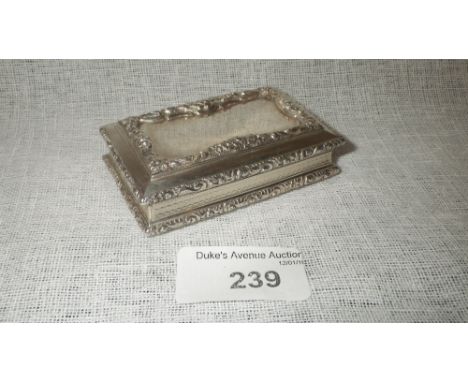 A VICTORIAN SNUFF BOX of rectangular form, with raised foliate scroll borders, engine-turned cushion sides and base, with gil