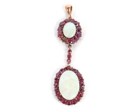 An opal and garnet pendant, the oval opal cabochon surrounded by garnets, with a three garnet drop and suspended below a larg