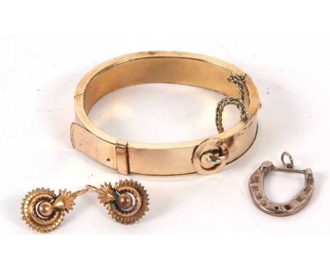 An early 20th century silver horseshoe brooch, hallmarked Birmingham 1937, 23mm long, 4.9g, together with a yellow metal buck