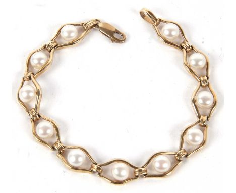A 9ct and cultured pearl bracelet, the round cultured pearls, approx. 6.5mm diameter, set within open eye shape links, stampe