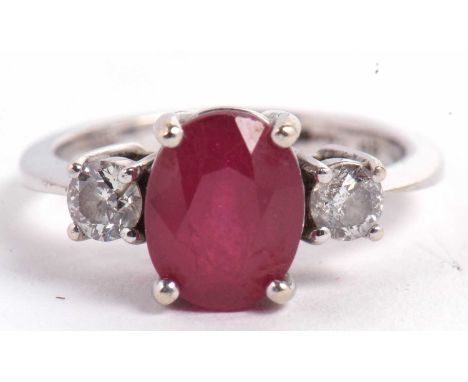 A 14ct white gold ruby and diamond ring, the oval mixed cut ruby, approx. 9.1 x 7.1 x 5.1mm, set with a round brilliant cut d