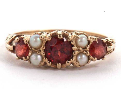 A 9ct garnet and cultured pearl ring, the three graduated round garnets interspaced with two small cultured pearls, with scro