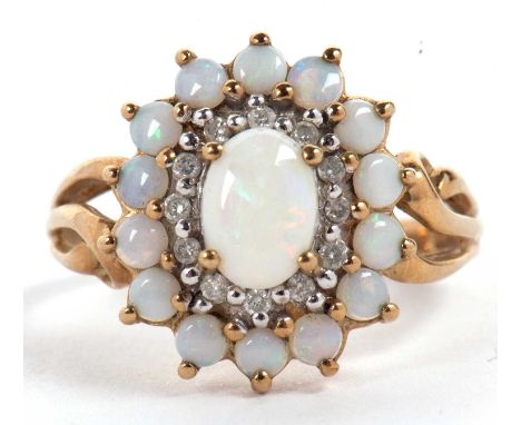 A 9ct opal and diamond cluster ring, the central oval opal cabochon surrounded by small round diamonds and further surrounded