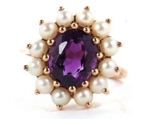 A 9ct amethyst and split pearl ring, the oval amethyst surrounded by split pearls, overall 16.8mm wide, all claw mounted to a