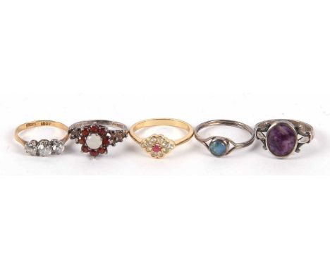 Five rings: a 9ct and white stone ring, an opal and garnet cluster silver ring, an opal triplet ring, an amethyst ring, and a