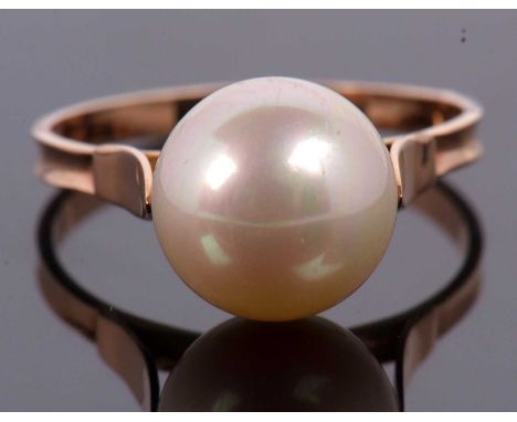 A cultured pearl ring, the cultured pearl approx. 1cm diameter, with cup and two claw mount, to a plain band of yellow metal,