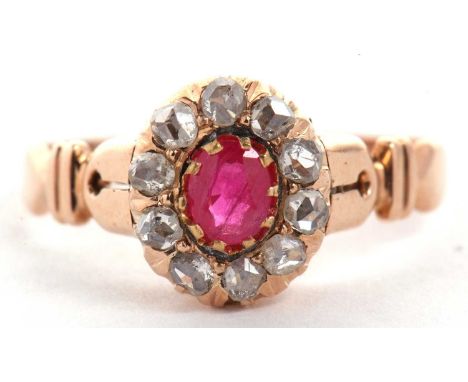 A ruby and diamond ring, the oval ruby surrounded by rose cut diamonds, all claw mounted with tapered shoulders and plain ban