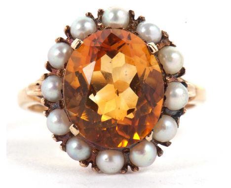 A 9ct citrine and cultured pearl ring, the oval citrine in a four claw mount and surrounded by small cultured pearls, with sp