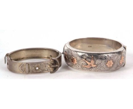 A silver hinged bangle, 22mm wide, with engraved decoration and bi-colour swallows and ivy decoration, inner diameter 6cm, ha