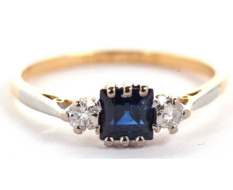 A 18ct and platinum sapphire and diamond ring, the central square step cut sapphire set to either side with a round, old cut 