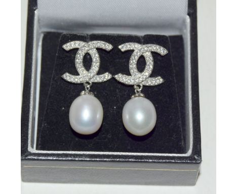 Pair of silver Chanel style earrings with pearl drops