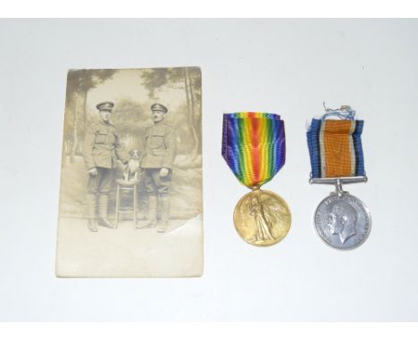 A WW1 medal pair named to G-12060 Private FA Elliott of the Middlesex Regiment with a photo postcard of him with his father w