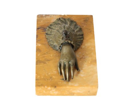 Brass Hand Paper Holder with Marble Base. The paper goes between the base and the hand. The hand has a button that you press 