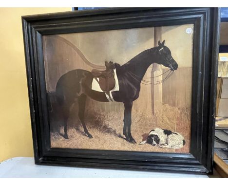 A DARK FRAMED PRINT OF A HORSE AND A DOG IN A STABLE 