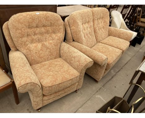 A VICTORIAN STYLE BUTTON BACK TWO SEATER AND MATCHING EASY CHAIR ON TURNED LEGS WITH BRASS CASTERS 