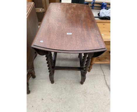 AN EARLY 20TH CENTURY OAK BARLEY TWIST GATE LEG DINING TABLE 