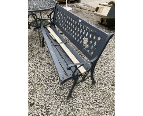 A WOODEN SLATTED GARDEN BENCH WITH CAST ENDS AND PLASTIC BACK 