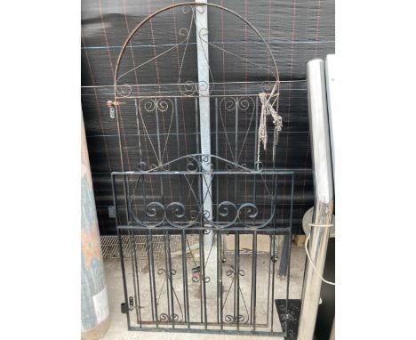 A TALL DECORATIVE WROUGHT IRON GATE AND A FURTHER LOW WROUGHT IRON GATE 