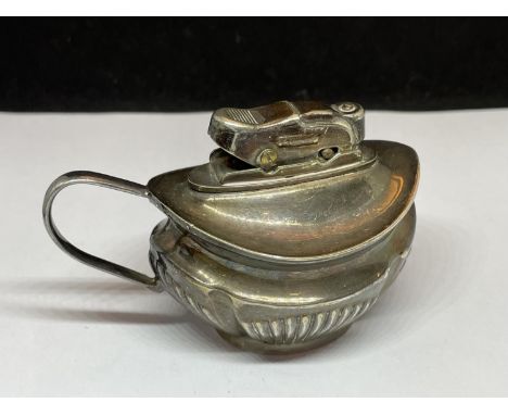 A SILVER PLATED TABLE LIGHTER IN THE FORM OF A JUG 