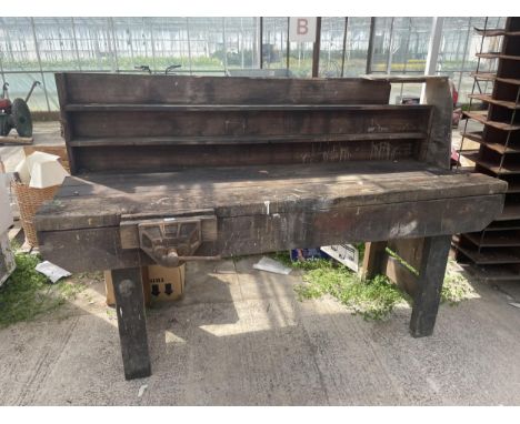 A VINTAGE WORKSHOP BENCH WITH A WOOD VICE 