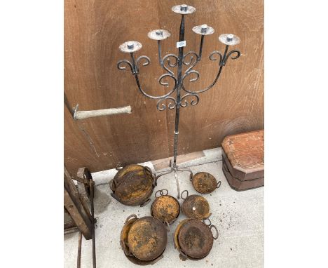 A FIVE BRANCH WROUGHT IRON CANDLE STICK AND AN ASSORTMENT OF CAST IRON COOKING DISHES 